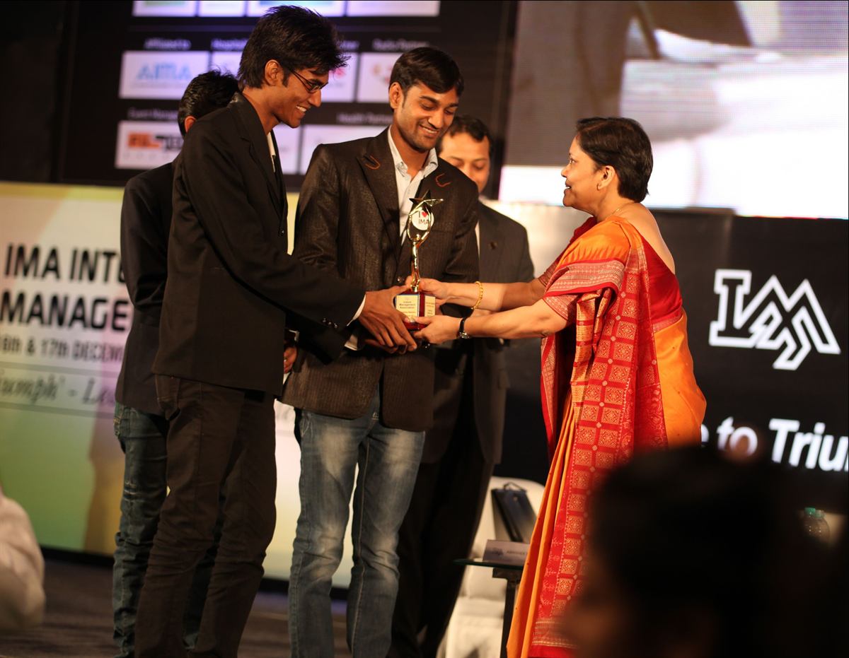 Mahesh Engla receiving recognition on stage